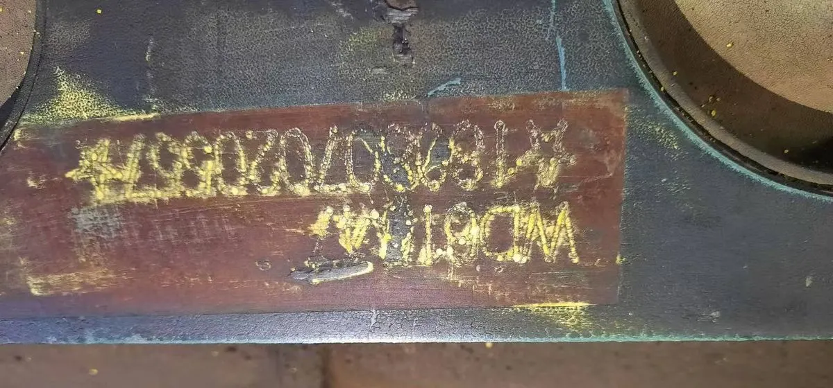 Cast part number 183070209647 stamped on the surface of a used truck component