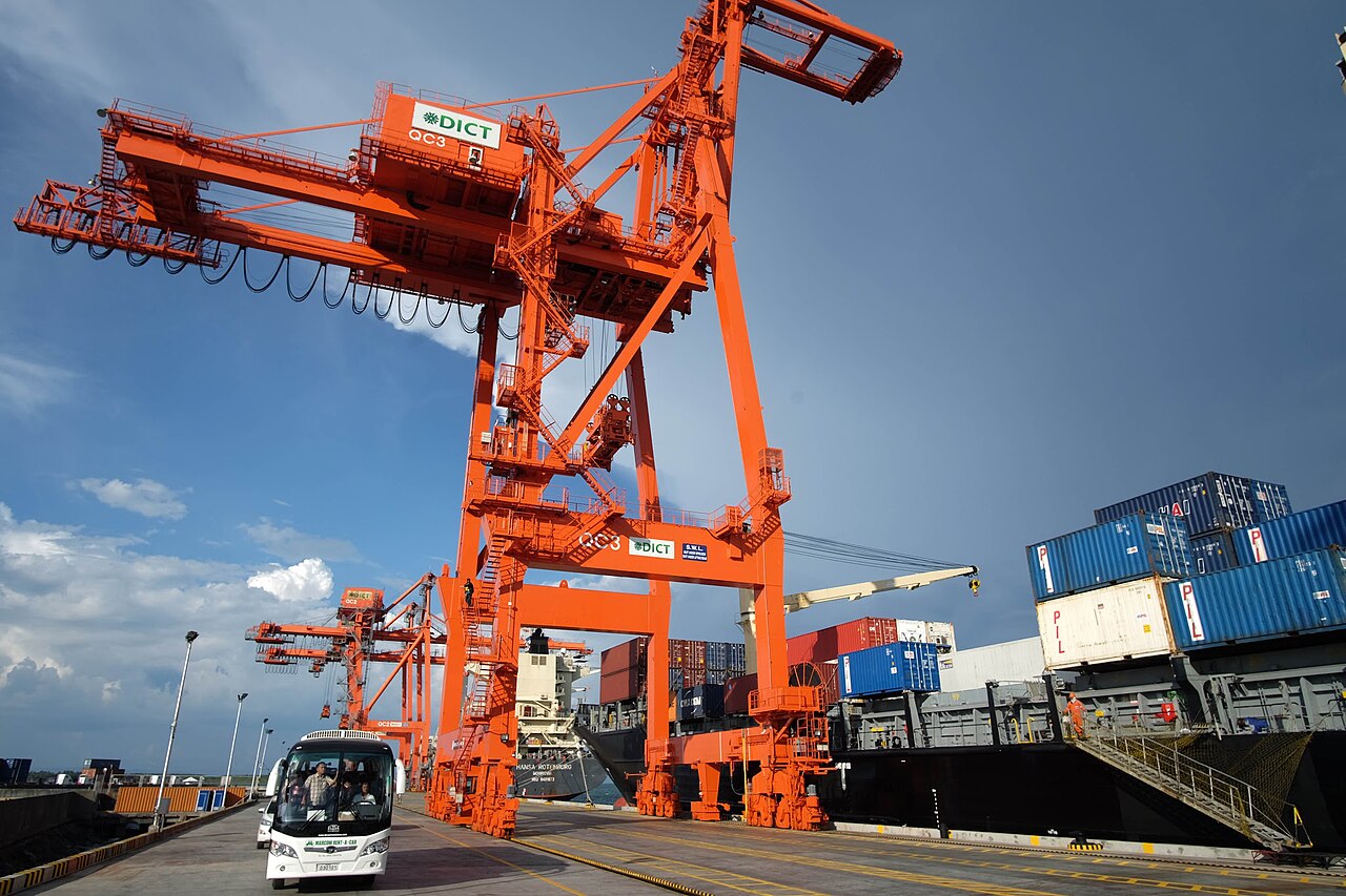 Gantry cranes loading a container ship at Davao International Container Terminal in the Philippines